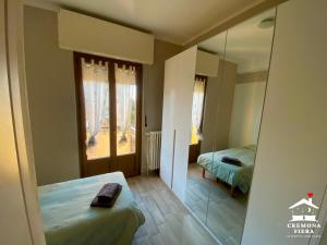 a room with a mirror and a bed and a bedroom at APPARTAMENTO CREMONA FIERA in Cremona