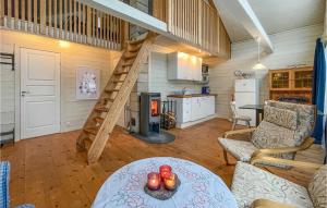 a living room with a spiral staircase in a house at 2 Bedroom Cozy Home In Klssbol in Klässbol