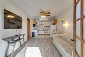 a living room with a couch and a ceiling fan at 1 Mi to Metro Station Cozy Aurora Horse Farm Apt! in Aurora