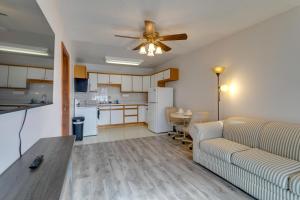 a living room with a couch and a ceiling fan at 1 Mi to Metro Station Cozy Aurora Horse Farm Apt! in Aurora