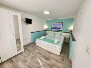 a small bedroom with a bed and a tv at Casa al mare Orchidea Relax, Moto parking e WiFi vicino alla spiaggia in Cala Gonone