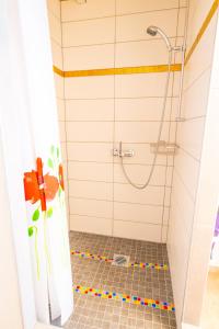 a bathroom with a shower and a tile floor at Residence Villa Flora in Interlaken