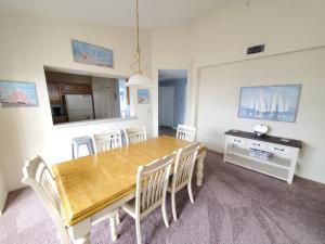 a dining room with a wooden table and chairs at Seaside at Anastasia 306 in Saint Augustine Beach