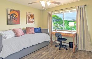 a bedroom with a bed and a desk and a window at Ko Olina Fairways #4E townhouse in Kapolei