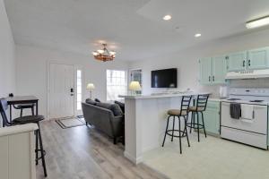 a kitchen and living room with a couch and a table at Convenient Colorado Horse Farm Apt with Balcony! in Aurora