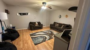 a living room with two couches and a ceiling fan at Ski on Ski off Mtn Chalet in Vernon