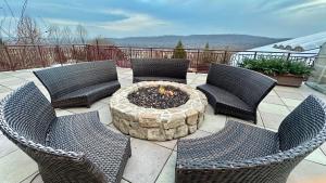a group of chairs and a fire pit on a patio at Ski on Ski off Mtn Chalet in Vernon