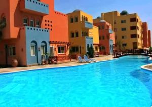 a swimming pool in front of some buildings at Al Dora Residence Suites Hurghada in Hurghada