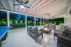 a screened in patio with a pool table at New Tropical Oasis Retreat in Miami in Miami