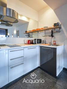 a large kitchen with white cabinets and a stove at Acquario Suites in Genova