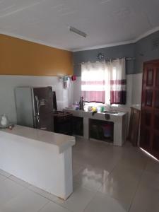 a kitchen with a sink and a refrigerator at Plush 3 Bedroom Apartment Home in Kitale
