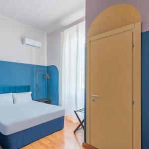 a bedroom with a bed and an open door at Hotel Infinito - Gruppo BLAM HOTELS in Rome