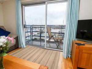 a living room with a large window with a view of a ship at Mountbatten House in Plymouth