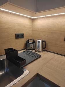 a kitchen counter with a toaster and a coffee maker at Cosy house with garden in Volos