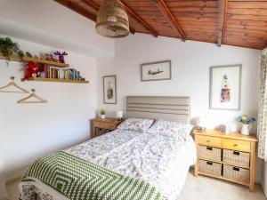 a bedroom with a bed and a wooden ceiling at Branwen in Porthmadog