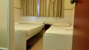 Postelja oz. postelje v sobi nastanitve Li Cheng Guesthouse