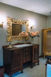 a bathroom with a vanity with a mirror on the wall at The Bohemian Guesthouse in Tzaneen