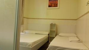 Postelja oz. postelje v sobi nastanitve Li Cheng Guesthouse