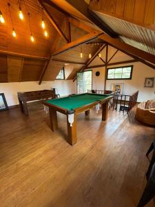 a large room with a pool table in it at Pousada Motta in Miguel Pereira