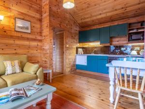 a kitchen and living room in a log cabin at 1 Bed in Clovelly 00354 in Clovelly