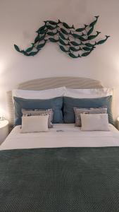 a bedroom with a large white bed with two pillows at B&B Casa Ninni in Camogli