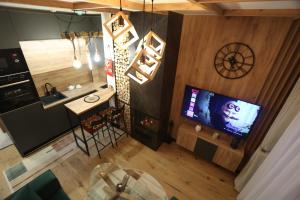 an overhead view of a kitchen and a living room with a television at City escape apartment Bjelasnica in Bjelašnica