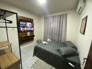 TV a/nebo společenská místnost v ubytování Quarto privativo no centro de Foz