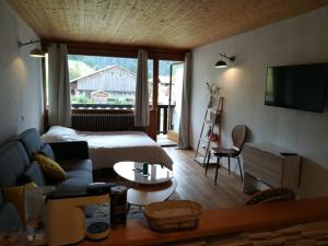 a bedroom with a bed and a couch and a table at Studio Crest-Voland, 1 pièce, 4 personnes - FR-1-733-147 in Crest-Voland