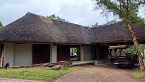 a house with a thatched roof at Ilanga Safari Lodge - Welgevonden Game Reserve in Vaalwater