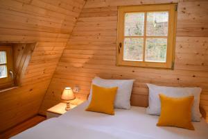 a bedroom with a bed in a log cabin at Vikendica Đoković 2 - Jahorina in Pale