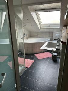 a bathroom with a bath tub and a sink at Saarbrücken City Saar in Saarbrücken