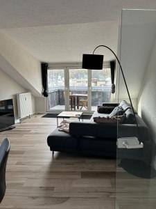 a living room with a bed and a lamp at Saarbrücken City Saar in Saarbrücken