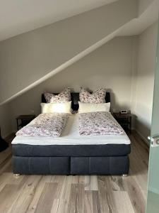 a bedroom with a bed with pillows on it at Saarbrücken City Saar in Saarbrücken