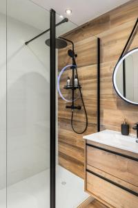 a shower with a glass door in a bathroom at Private Apartment - Family - Palais des Festival - Parking - Cannes in Cannes