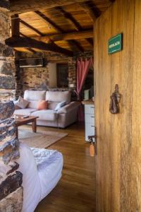 a open door to a living room with a couch at Cabo Do Mundo Casa Rural in Chantada