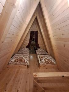 a room with two beds in a attic at Wooden cottages "KONAK" in Šavnik