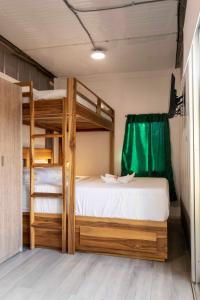 a bedroom with a bunk bed with a ladder at Emi’s Place Container Living in Uvita