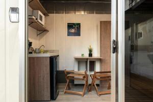 a room with a kitchen and a table and chairs at Emi’s Place Container Living in Uvita