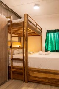 a bedroom with two bunk beds and a window at Emi’s Place Container Living in Uvita