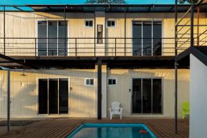 a house with a swimming pool in front of it at Emi’s Place Container Living in Uvita