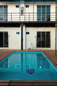 a swimming pool in front of a building at Emi’s Place Container Living in Uvita