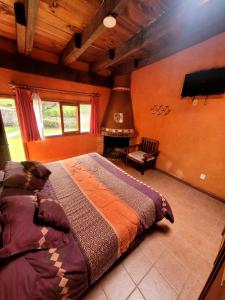 a bedroom with a bed and a flat screen tv at Hotel Casa Valle in Valle de Bravo