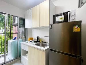 a kitchen with a stainless steel refrigerator and a sink at Phuket Kathu - Fresh Oxygen in Phuket Town