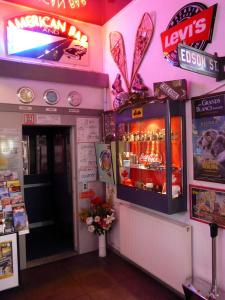 a restaurant with a bar with a display of drinks at Arche Hotel in Vierzon