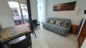 a living room with a table and a couch at Apartamentos Eduardo Rico in Nerja