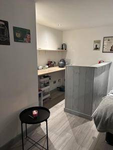 a living room with a table and a kitchen at Cosy open plan Cabin in Dublin 11 suit 2 persons in Dublin