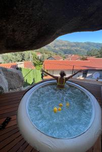 a woman is sitting in a jacuzzi tub at Pura Vida Matos House in Fafião