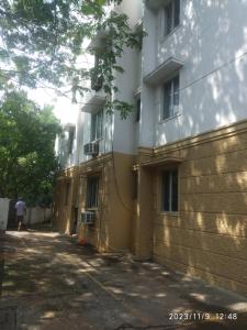 a building with a wall next to a building at Royale Seaward Cozy Suite in Chennai