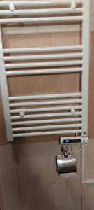 a toilet paper dispenser on a bathroom stall at Уютная квартира в комплексе Snow Lodge in Bansko +35 photos