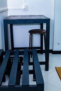 a blue table with a stool and a table with a bench at Sanasuma Hotel in Hambantota